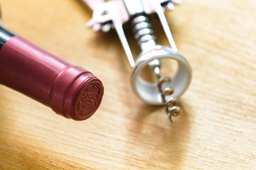 Bottle of red wine with a corkscrew