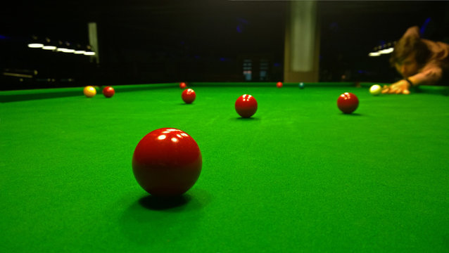 A man plays Billiards. Bright colorful balls to play snooker