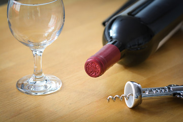 Bottle of red wine with glasse and corkscrew