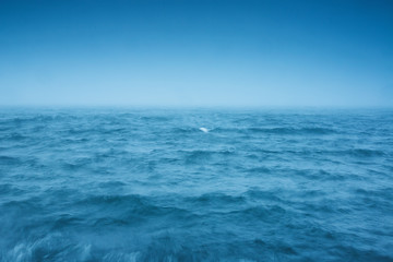 Fototapeta na wymiar Fog over the sea waves, natural background