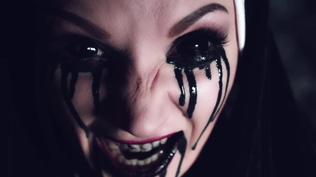 4k Halloween Shot of a Horror Woman Screaming with Blackout Eyes, close-up