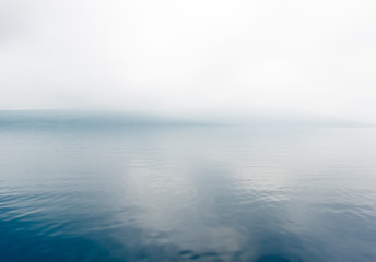 Fototapeta na wymiar foggy blue lake 