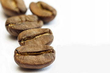 Broun coffee beans isolated on white background. shallow depth o