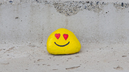 Painted pebble with a smiley