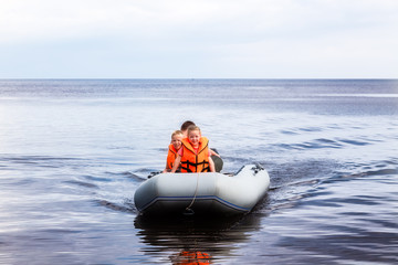 Children are floating in a rubber boat