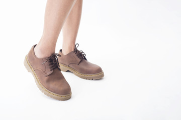 women legs in leather boots fashion side view isolated on the white background.