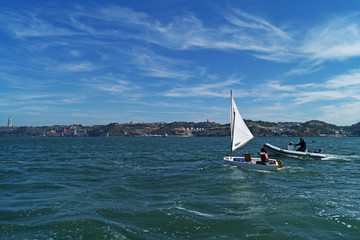 Girl with the coach involved in sailing on a sunny day
