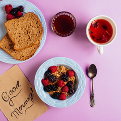 Breakfast table with waffles, granola and fresh berries
