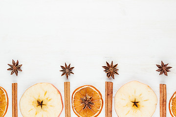 Christmas food - mulled wine background. Decorative frame of spice ingredients -  anise stars, cinnamon, dried oranges and wine on wood white surface. Top view.