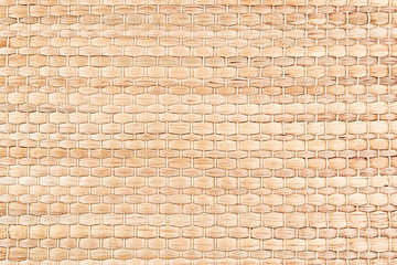 Bamboo woven beige mat handmade background. Wicker wood texture. Horisontal strips.