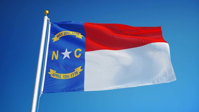 North Carolina (U.S. state) flag waving in slow motion against blue sky, seamlessly looped, close up, isolated on alpha channel with black and white matte, perfect for film, news, composition