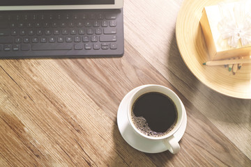 Obraz na płótnie Canvas Coffee cup and Digital table dock smart keyboard,gold gift box a