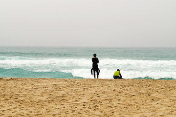 Two surfers are back on the ocean, Portugal.