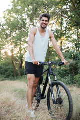 Obraz premium Full length cyclist on forest road