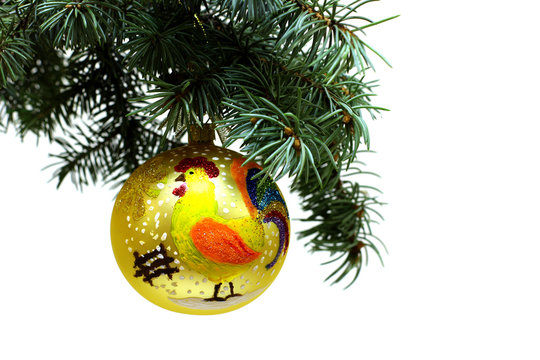 2017 new year of roosters in Chinese calendar. Christmas tree fir branch with gold ball decorated hand paint glitter rooster with colorful tale. Isolated on white background.