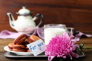 French delicious dessert macaroons with milk on the table. 