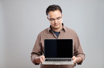 Man holding and showing laptop computer