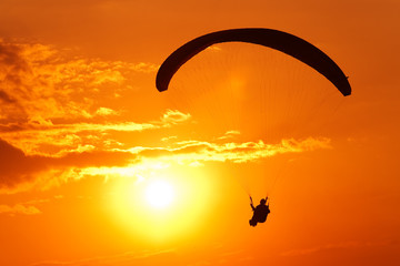Flying with a para-glider at sunset