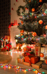 Fototapeta na wymiar Christmas room interior design, decorated tree in garland lights