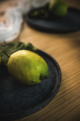 Fresh ripe citrus. Lemons, limes on dark background