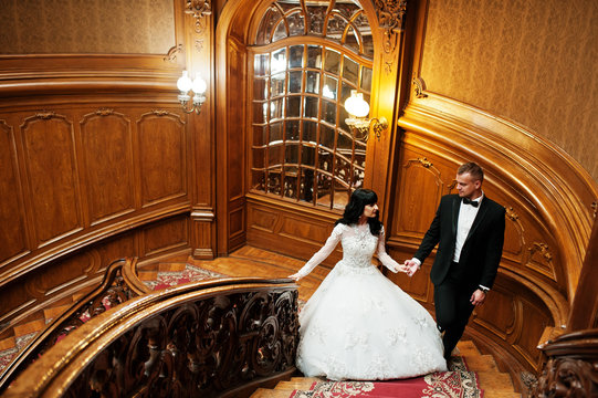 Magnificent wedding pair newlywed at rich wooden royal palace.