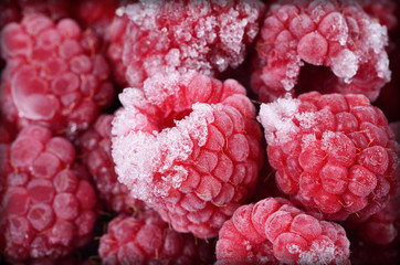 Red frozen raspberries background close-up photo