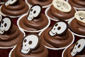  cupcakes for Halloween with  chocolate frosting and dark backgr