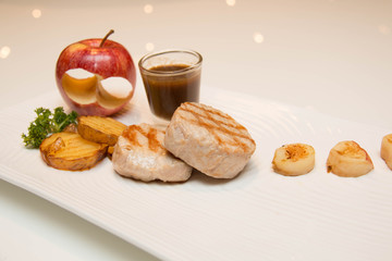 Pork meat grilled with potato  and apple sauce
