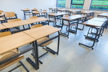 Rows of tables and chairs in classroom