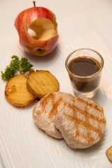 Pork meat grilled with potato  and apple sauce