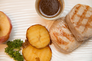 Pork meat grilled with potato  and apple sauce