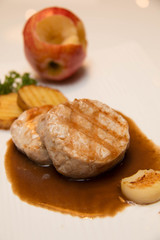 Pork meat grilled with potato  and apple sauce