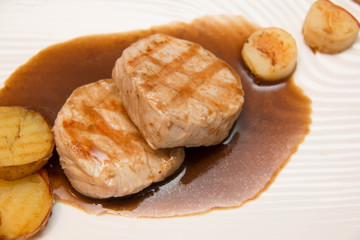 Pork meat grilled with potato  and apple sauce