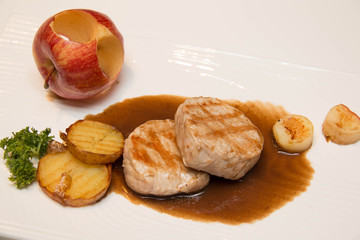 Pork meat grilled with potato  and apple sauce