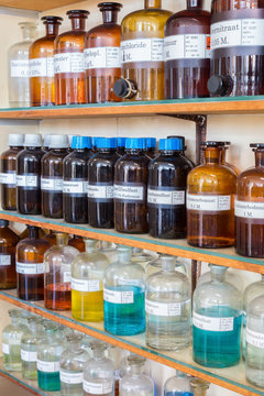 Rows of fluid chemicals in bottles at chemistry education