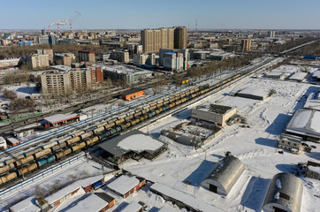 Fototapeta na wymiar Tyumen, Russia - March 11, 2016: Railroad along 50 let VLKSM Street, dividing residential and industrial districts of city