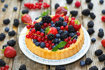 Cake with different berries - strawberries, blueberries, currant