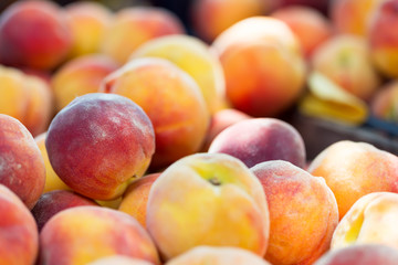 Fresh ripe organic peaches at market. Soft focus