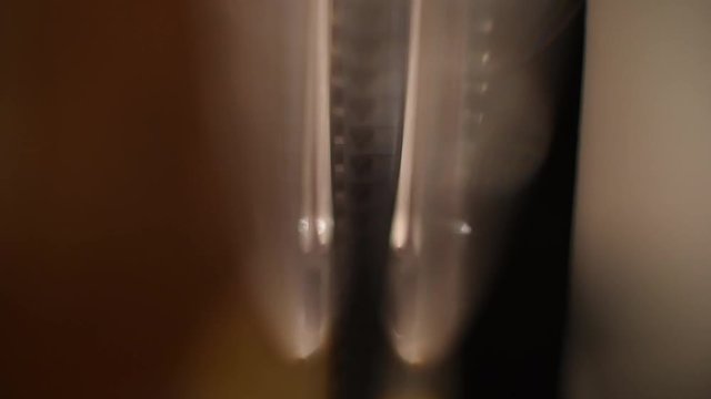 Blurred detail of projector film reel spool running with super 8 filmstrip