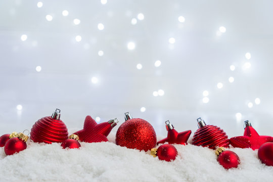 Christmas scene with snow - row of red balls with lights in background