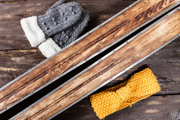 Overhead view of retro ski accessories placed on old rustic wood