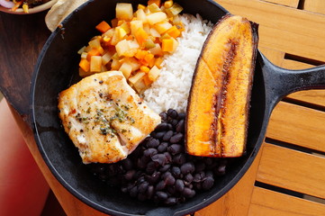 Traditional Costa Rican Casado meal with rice, beans, plantains and fish © eqroy
