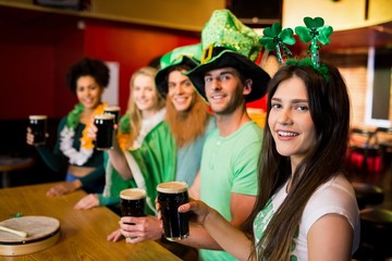 Smiling friends with Irish accessory