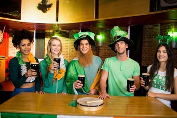 Smiling friends with Irish accessory