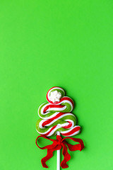 Christmas time. Swirled Christmas tree on green background