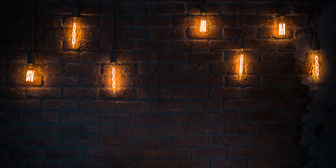 Light bulbs lamps on dark red brick background