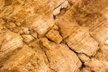 Yellow rock texture. Stones with cracks. Mother nature builds might. Place of geological research.