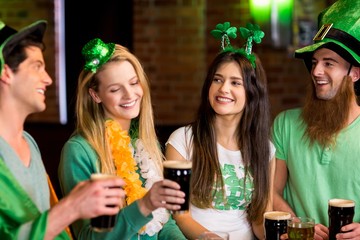 Smiling friends with Irish accessory