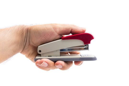 man hand holding a stapler isolated on a white background