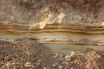 Stones and soil. Layer of yellow sand. Crust of the Earth. Dig deeper and explore.
